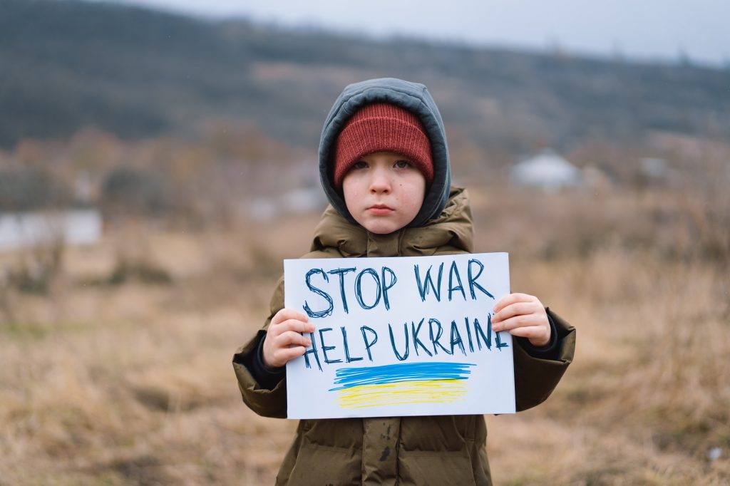 War of Russia against Ukraine. Crying boy asks to stop the war in Ukraine.