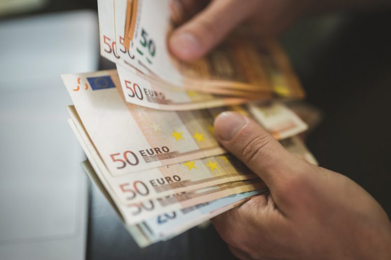 man counting money. male hands holds and count cash banknotes 50 euros bills currency