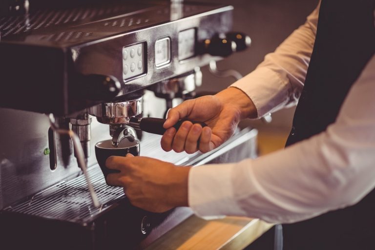 Waiter using coffee machine