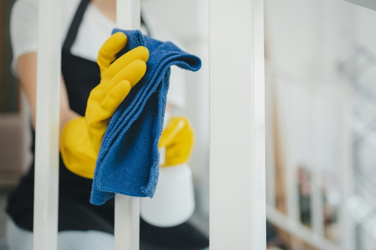 Housekeeper cleaning the furniture at home, Wear an apron and rubber gloves to protect against clean
