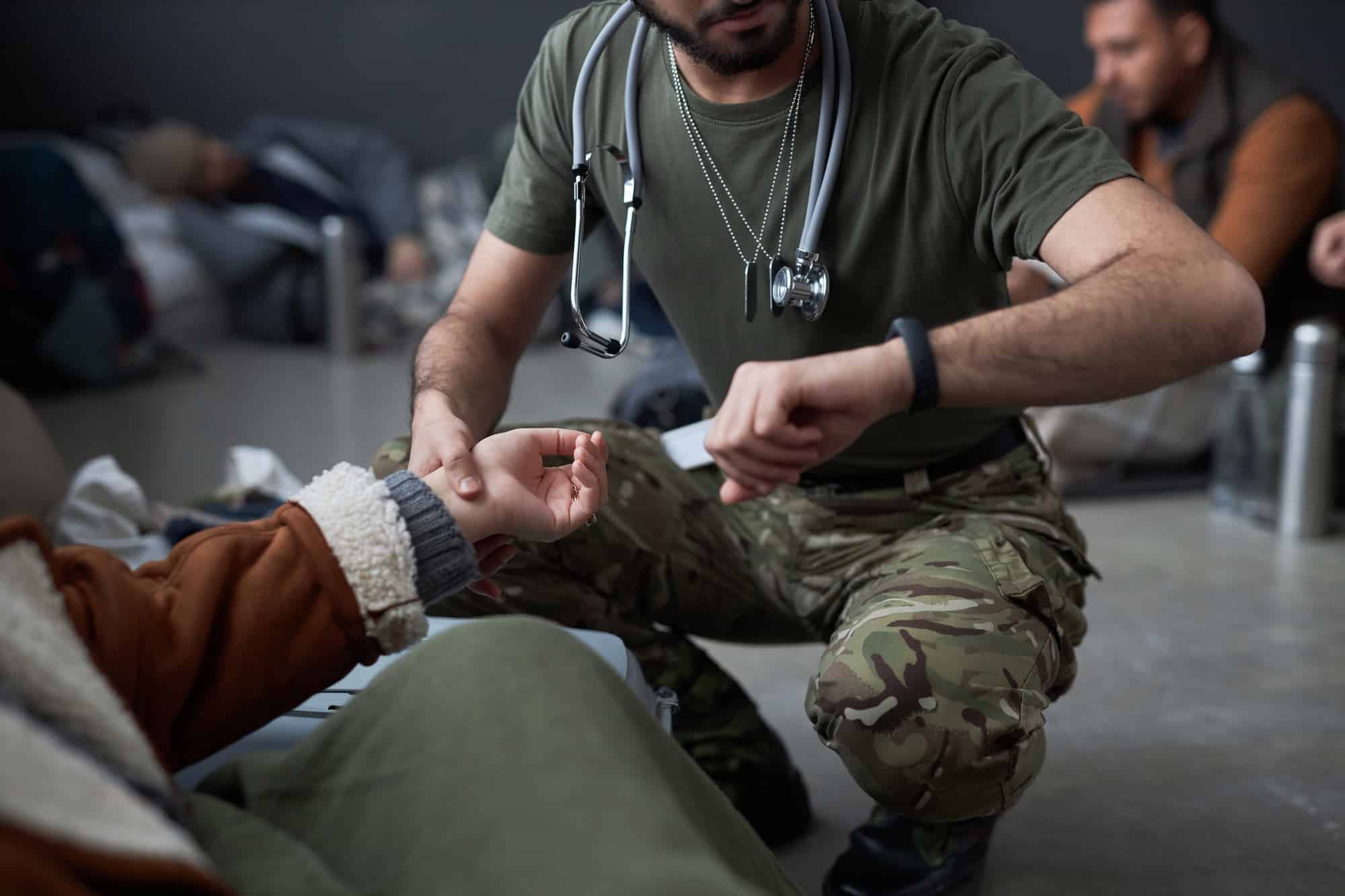 Doctor Examining Female Refugee in Shelter